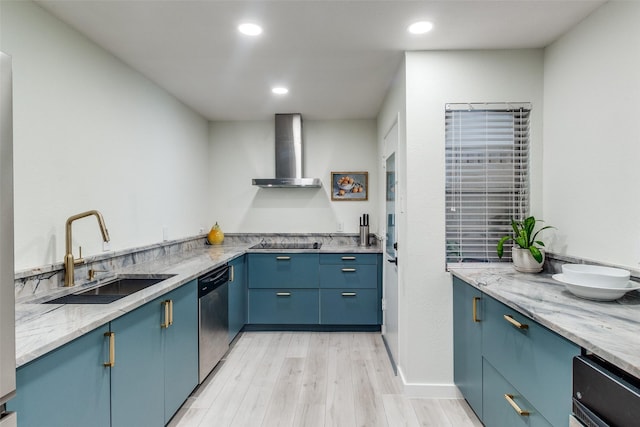 kitchen with sink, light stone counters, stainless steel dishwasher, wall chimney exhaust hood, and light wood-type flooring