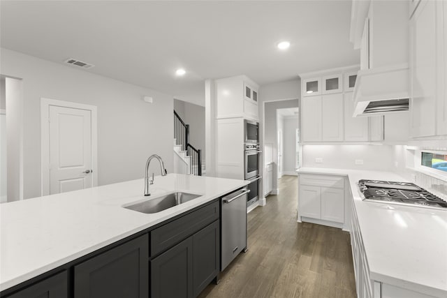 kitchen featuring a sink, stainless steel appliances, white cabinets, visible vents, and light countertops