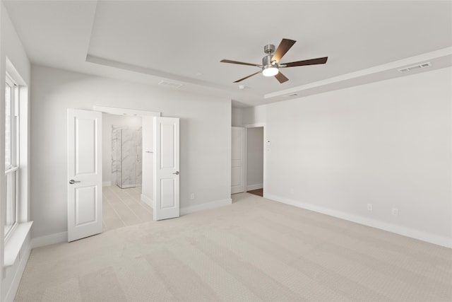 unfurnished bedroom featuring light carpet, baseboards, and visible vents