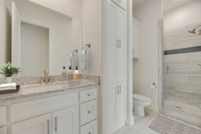 bathroom featuring vanity, toilet, and walk in shower