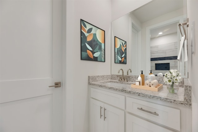 bathroom with a shower and vanity