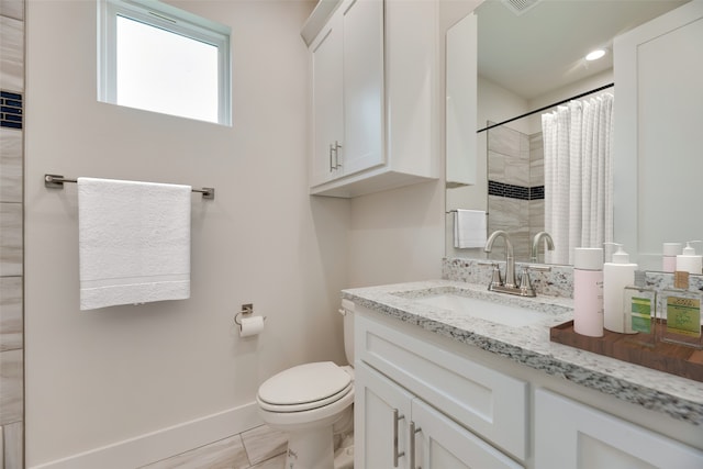 bathroom with tile patterned flooring, vanity, toilet, and curtained shower