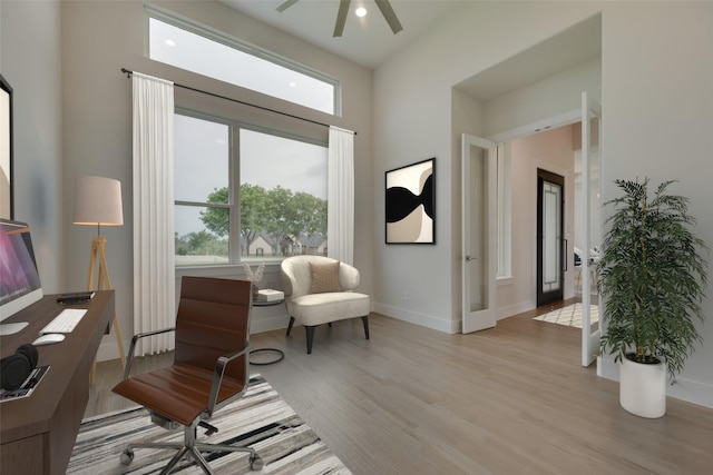 sitting room featuring french doors, light hardwood / wood-style flooring, and ceiling fan