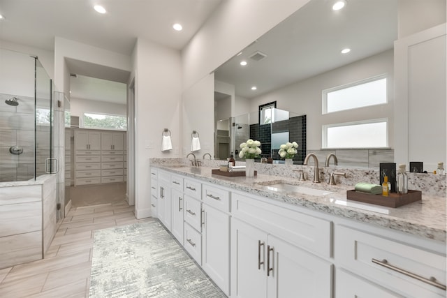 bathroom featuring vanity, tile patterned floors, and a shower with shower door