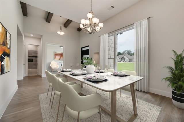 dining room with beamed ceiling, light hardwood / wood-style floors, and a chandelier