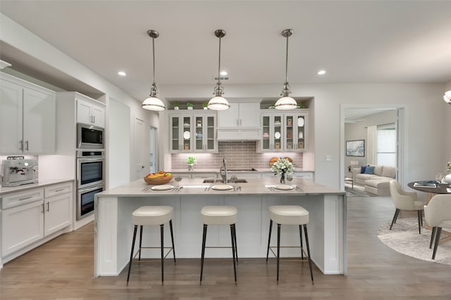 kitchen with pendant lighting, decorative backsplash, and white cabinetry