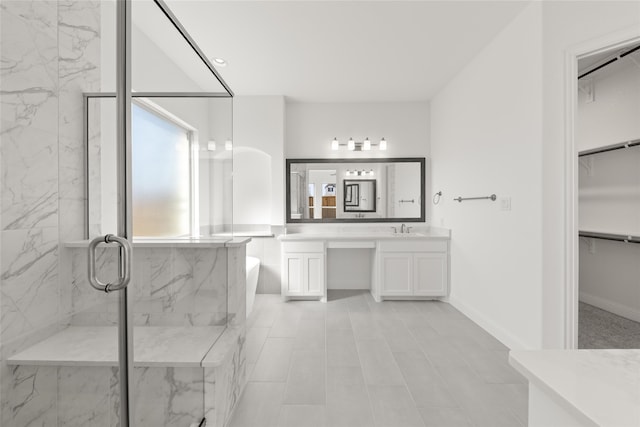 bathroom featuring walk in shower and vanity