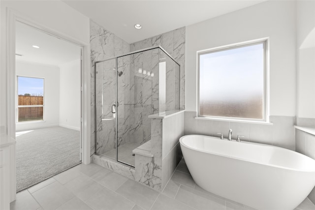 bathroom with separate shower and tub and tile patterned floors