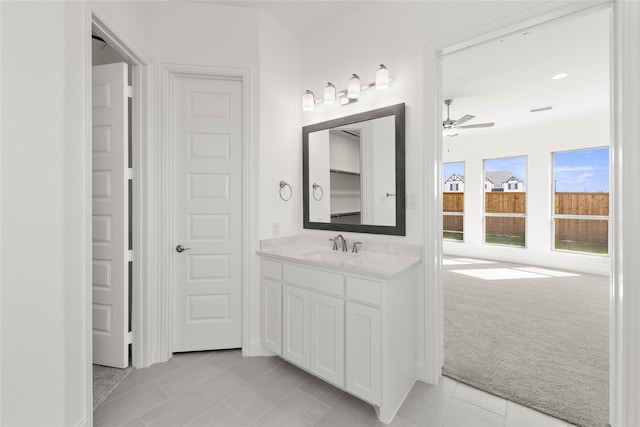 bathroom with tile patterned flooring, ceiling fan, and vanity