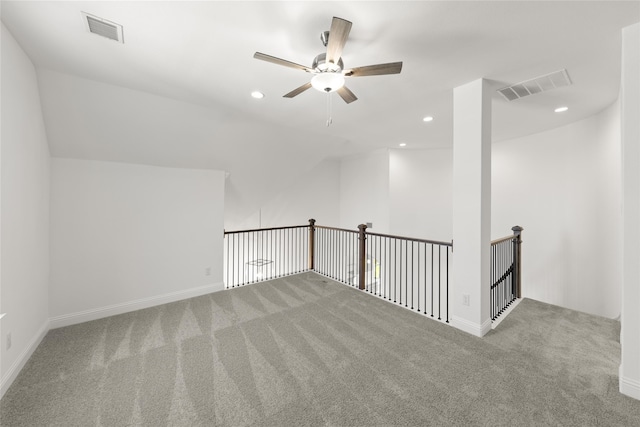 carpeted spare room featuring ceiling fan and lofted ceiling