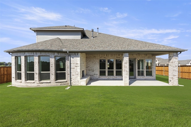 back of property with a patio area and a yard