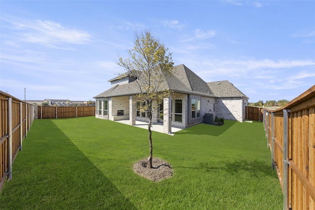 back of property with cooling unit, a yard, and a patio area