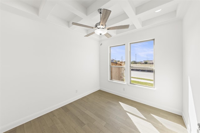 unfurnished room with coffered ceiling, beam ceiling, light hardwood / wood-style floors, and ceiling fan