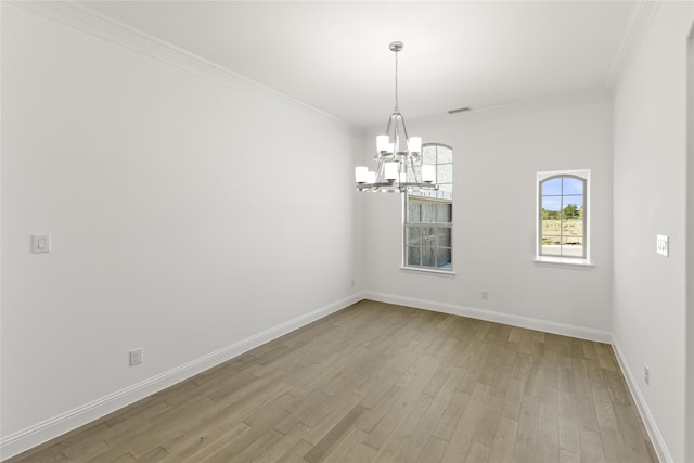 spare room with light hardwood / wood-style flooring, a chandelier, and crown molding