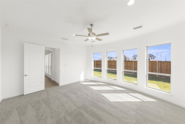 spare room featuring ornamental molding, ceiling fan, and carpet floors