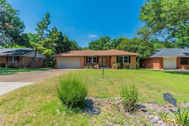 ranch-style house featuring a garage and a front yard