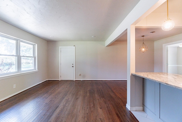 unfurnished living room with dark hardwood / wood-style flooring