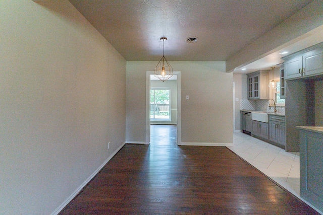 unfurnished dining area featuring sink and dark tile patterned flooring