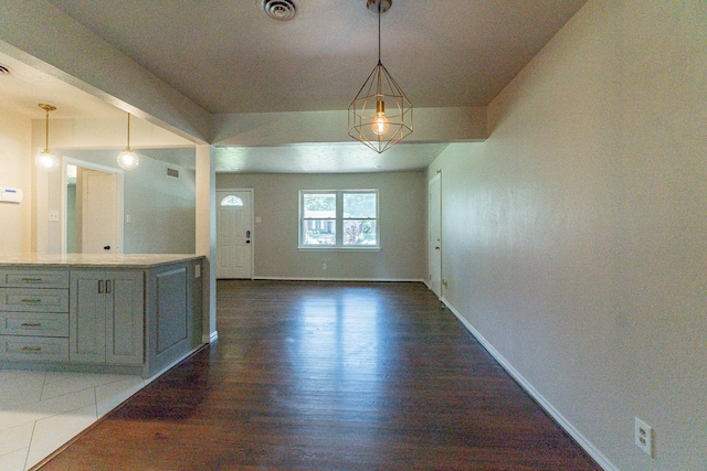 unfurnished dining area with dark wood-type flooring