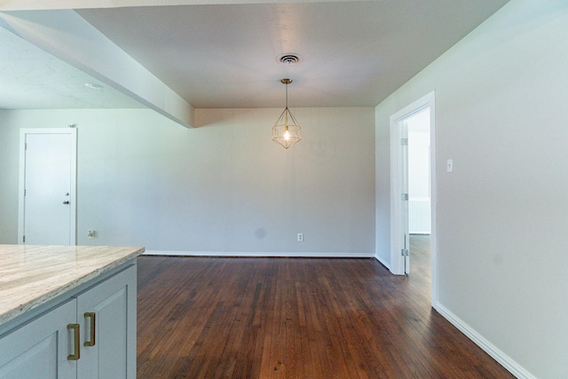 unfurnished dining area with dark hardwood / wood-style flooring