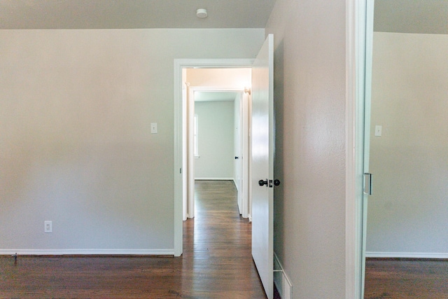 corridor with dark wood-type flooring