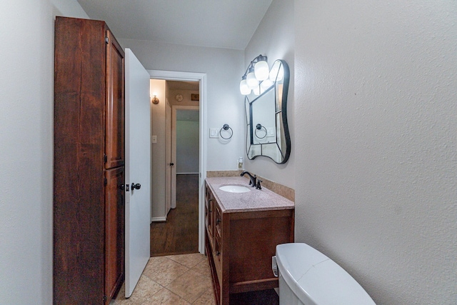 bathroom with vanity, tile patterned floors, and toilet