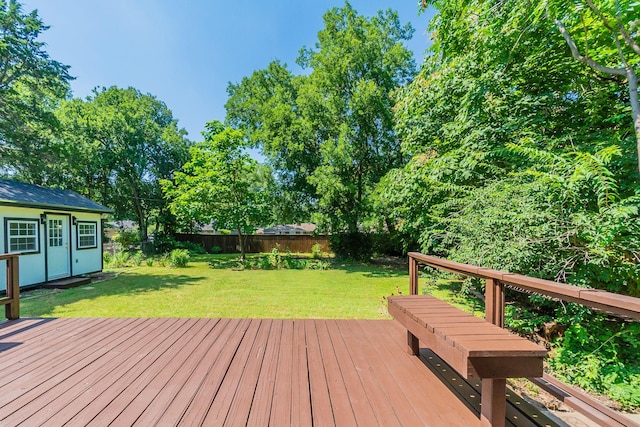 wooden deck featuring a lawn