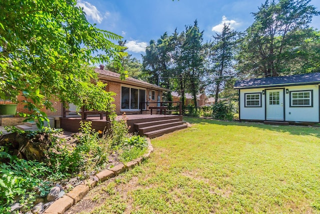 view of yard featuring an outdoor structure and a deck