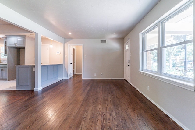 empty room with dark hardwood / wood-style floors