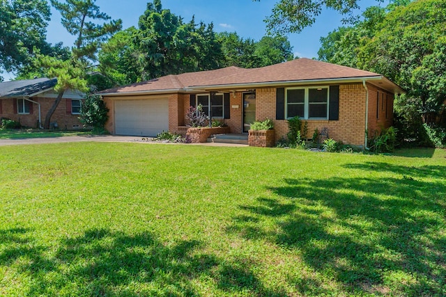 ranch-style home featuring a garage and a front lawn