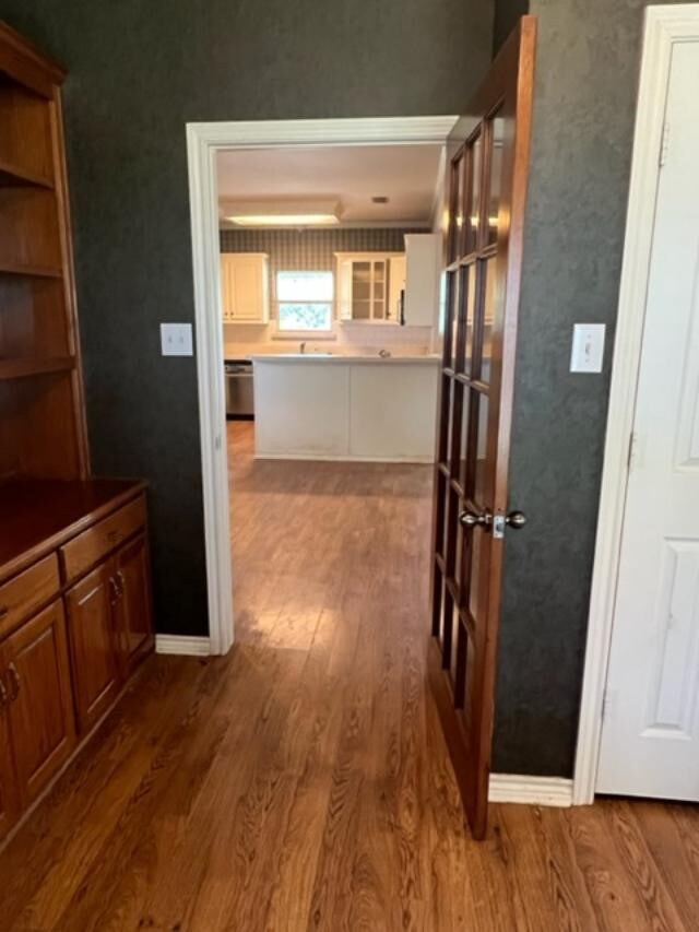 hallway with hardwood / wood-style flooring