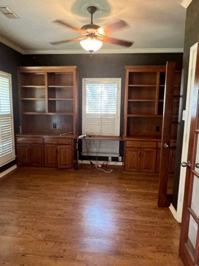 interior space featuring ceiling fan, dark hardwood / wood-style flooring, and crown molding