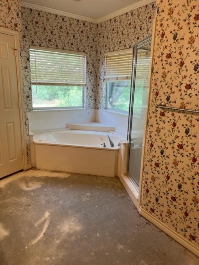 bathroom featuring crown molding and shower with separate bathtub