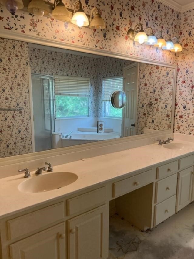 bathroom featuring vanity, crown molding, and plus walk in shower