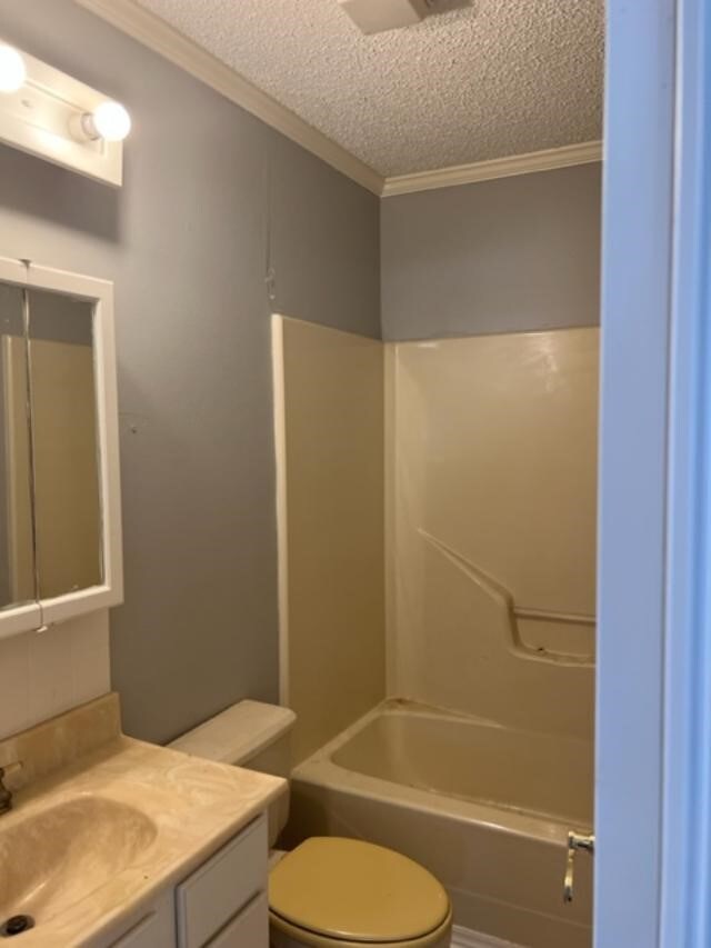 full bathroom with vanity, toilet, shower / bath combination, and a textured ceiling