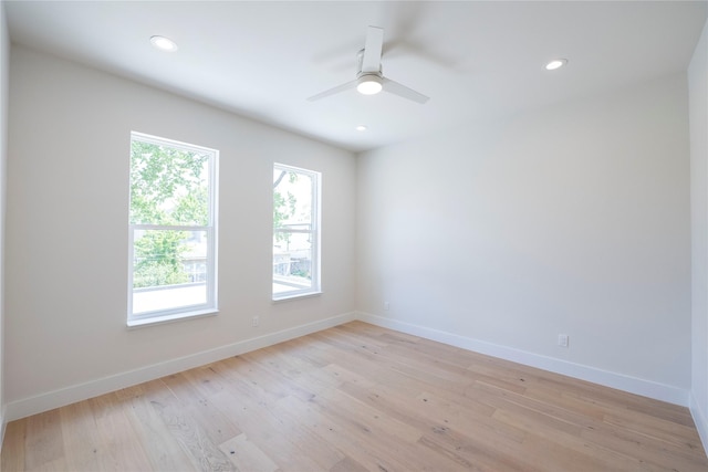 unfurnished room with ceiling fan and light hardwood / wood-style floors