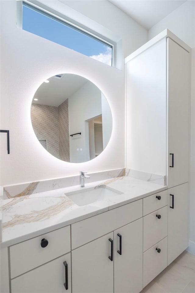 bathroom featuring tile patterned flooring and vanity