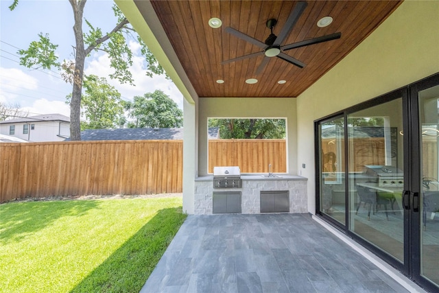 view of patio / terrace with ceiling fan, a grill, sink, and an outdoor kitchen