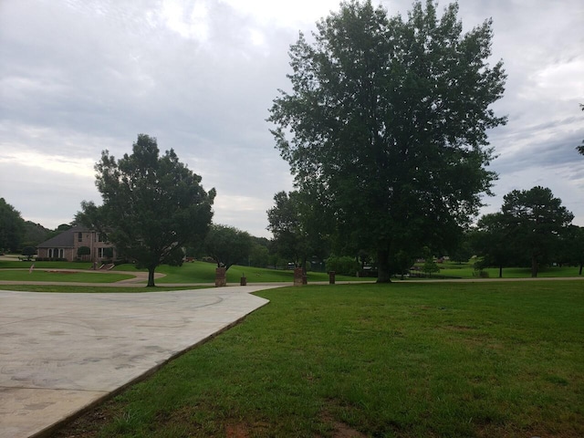 view of property's community with a lawn