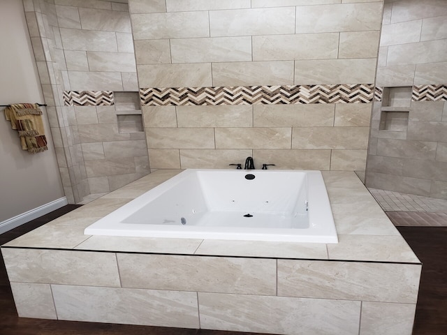 bathroom featuring tiled bath