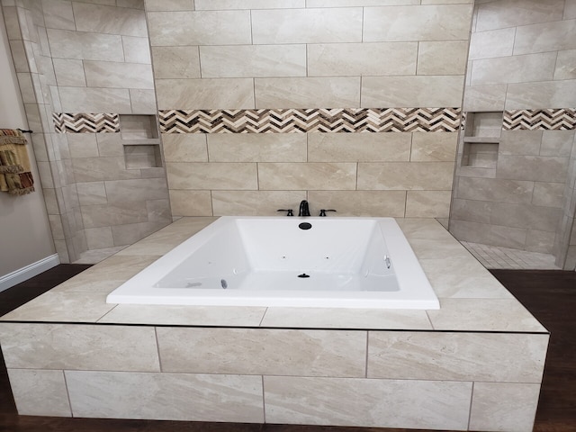 bathroom featuring tiled bath