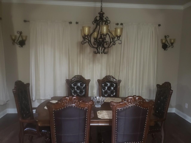 dining space with ornamental molding and a notable chandelier