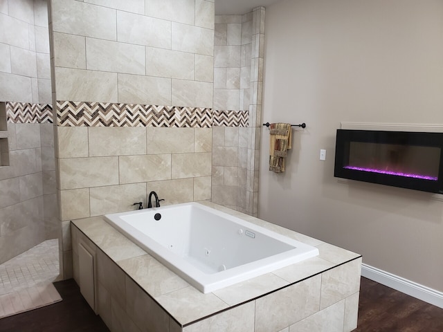 bathroom with hardwood / wood-style floors and independent shower and bath