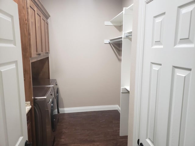 laundry room with washer and dryer, cabinets, and dark wood-type flooring