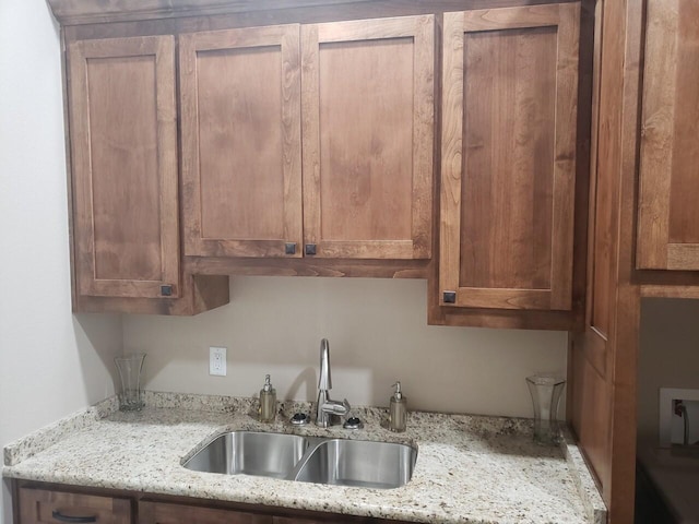 kitchen with light stone counters and sink