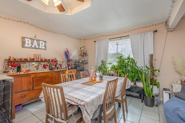 dining space featuring ceiling fan, wine cooler, and light tile patterned floors