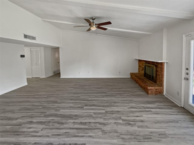 unfurnished living room featuring ceiling fan, light hardwood / wood-style floors, lofted ceiling with beams, and a fireplace