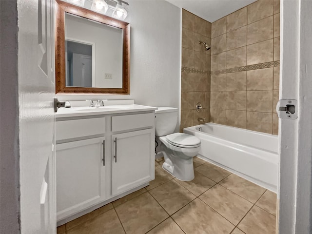 full bathroom featuring toilet, vanity, tile patterned floors, and tiled shower / bath