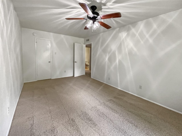 unfurnished bedroom with ceiling fan, a closet, and carpet floors