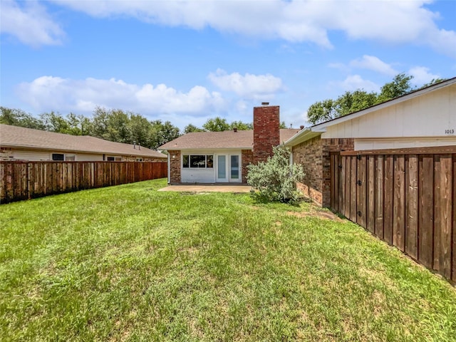 back of house featuring a patio and a lawn